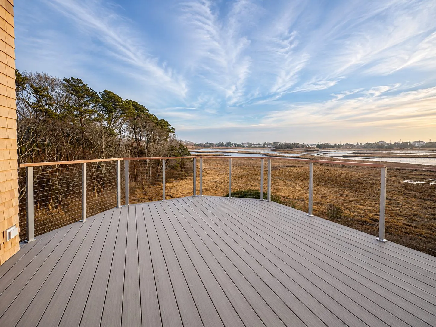 Composite deck with cable rail facing a salt marsh