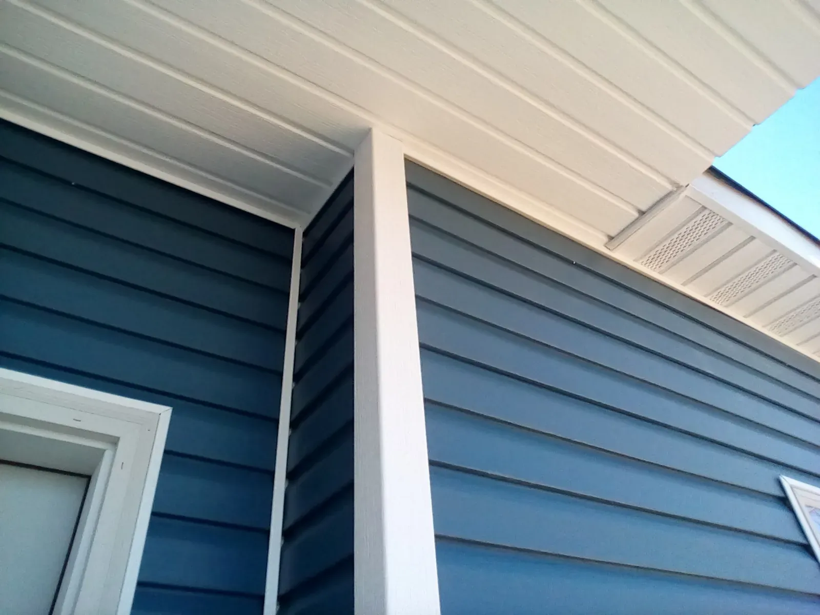 White vinyl trim on blue siding
